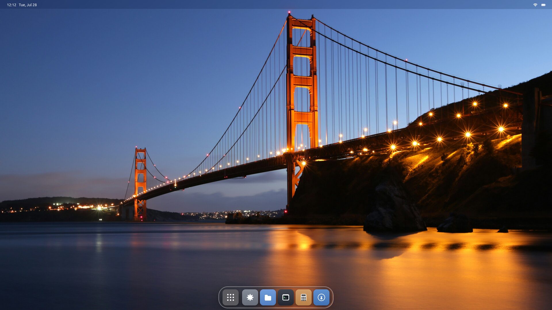 The Starling desktop: a menu bar with the clock across the top, a wallpaper of the Golden Gate Bridge at dusk, and a floating glass dock at the bottom holding six app icons.
